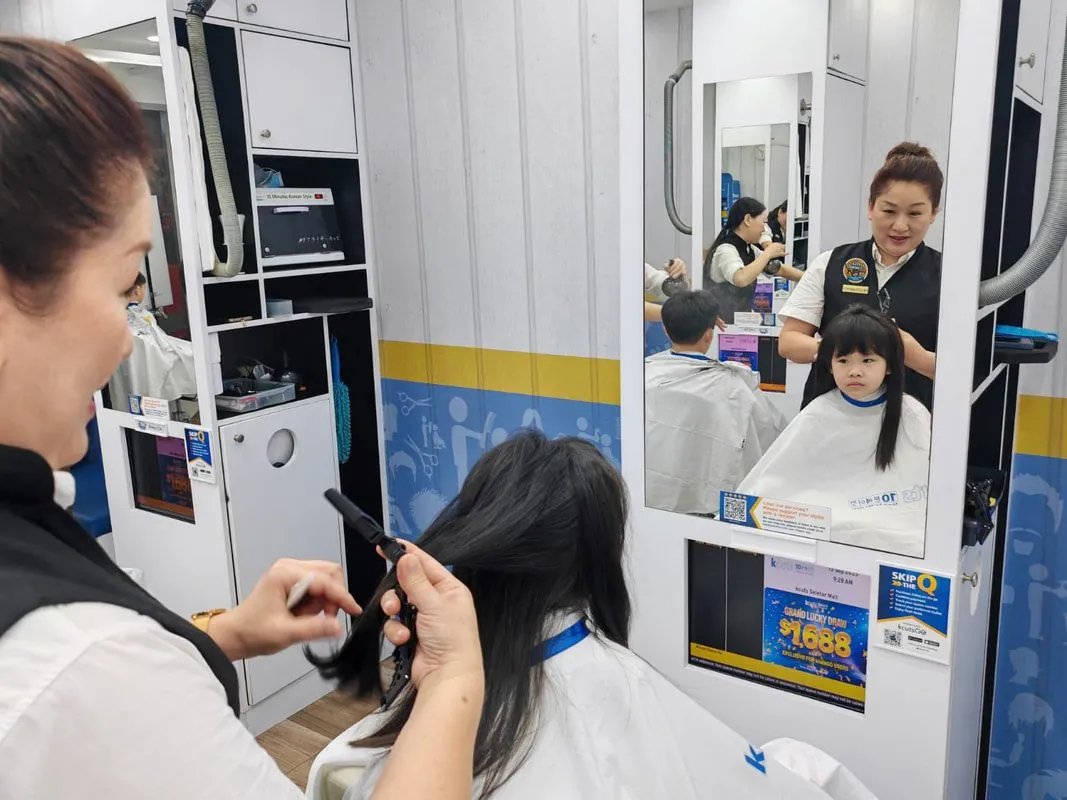 A child getting a haircut at kcuts