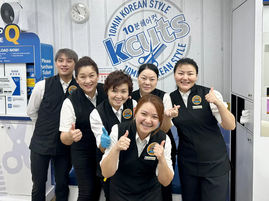 A young customer smiling at kcuts